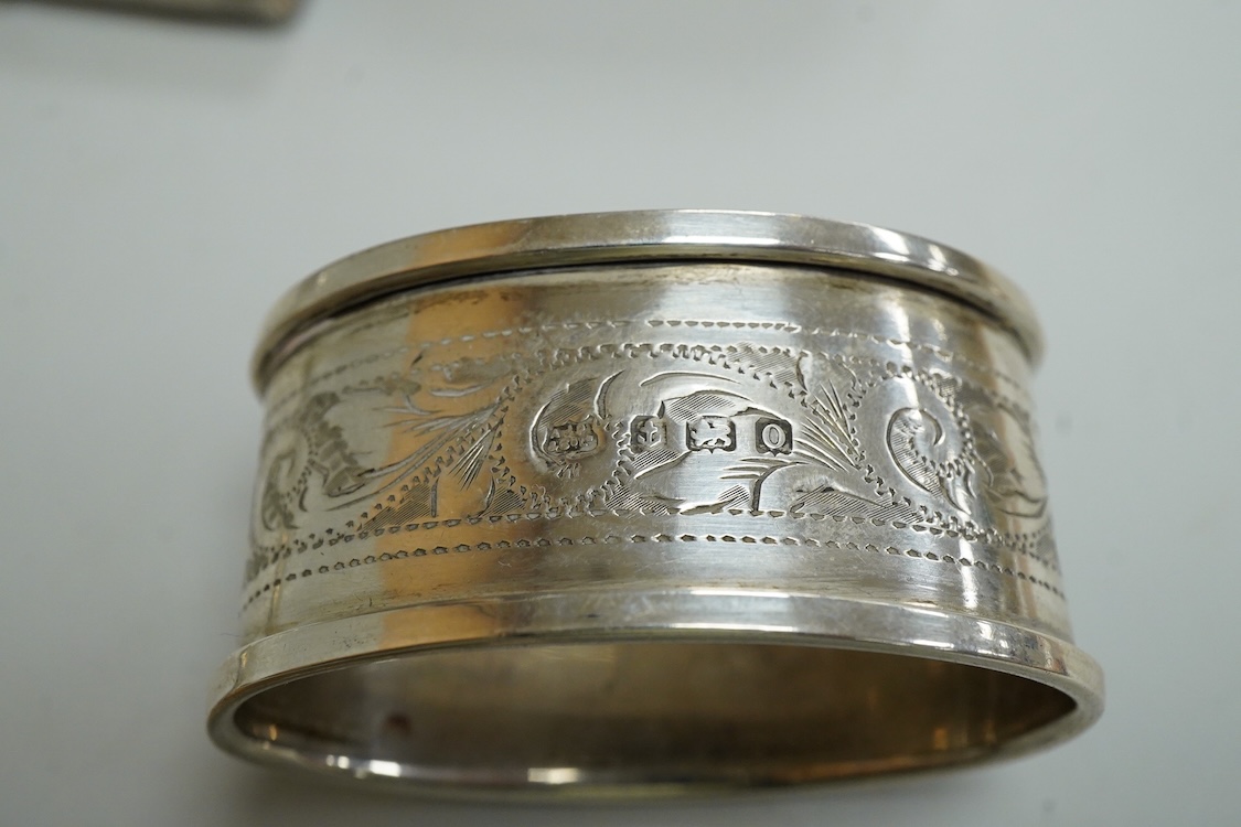 Three assorted silver napkin rings, a pair of recent 925 napkin rings, a George V silver mounted hand mirror, a modern silver mounted spill vase and a late Victorian silver vesta case.